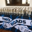 Two Roads welcomed guests with craft beer glasses, stickers, and bottle openers to take home.